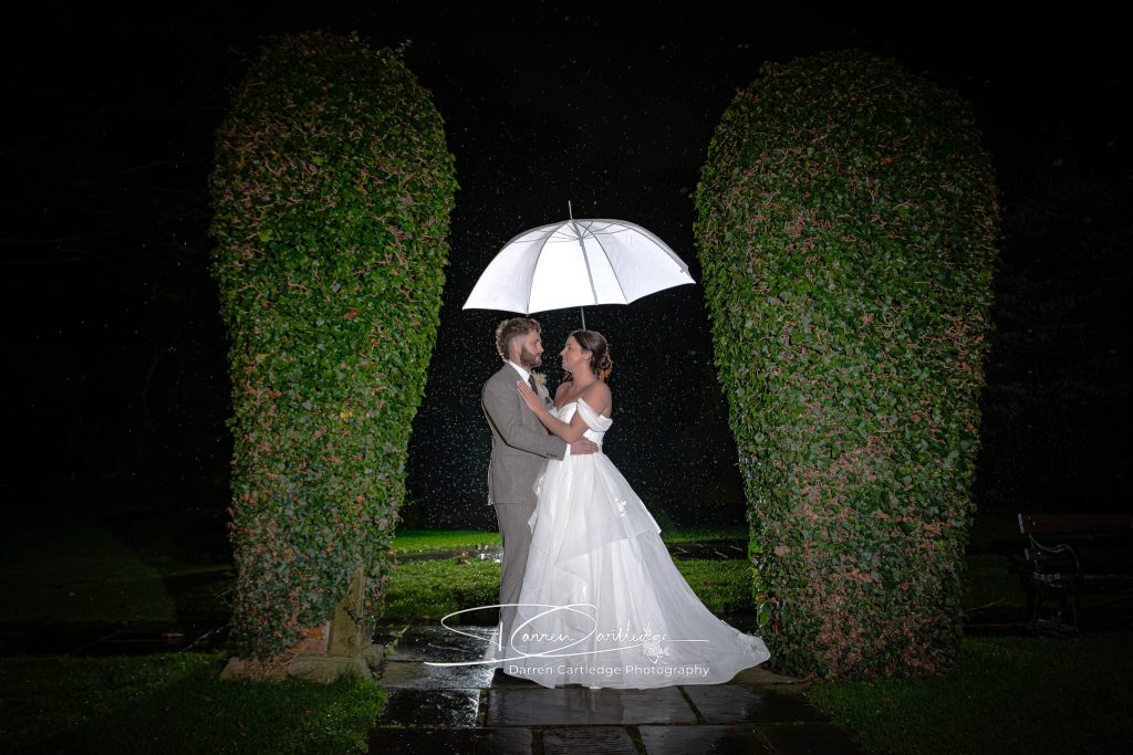 Yorkshire Wedding Photographer - Bride and Groom in rain at Whitley Hall
