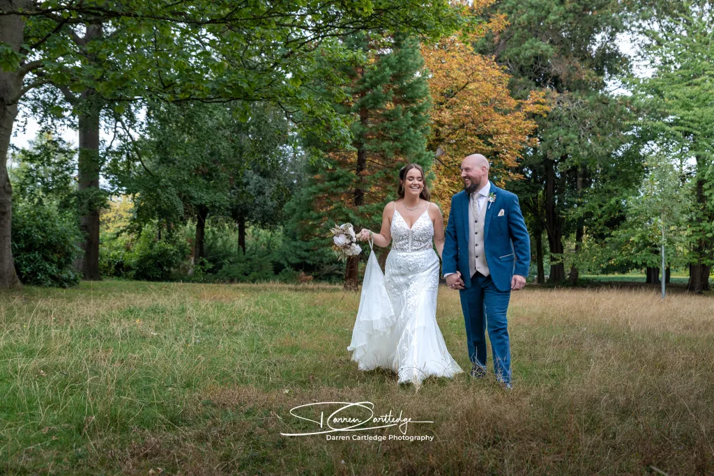 Bride and groom walk hand-in-hand in East Yorkshire.