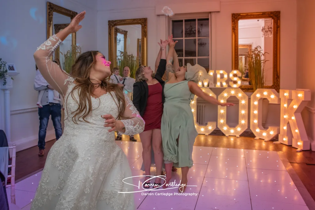 Leeann with guests during the garter toss on the dance floor at Bawtry Hall