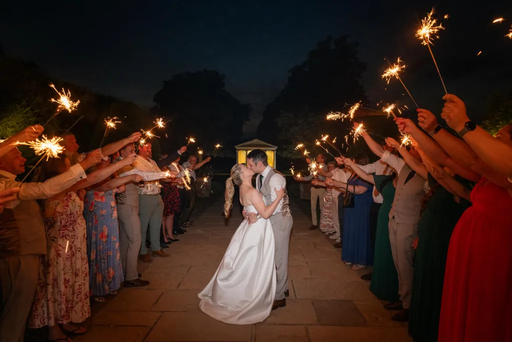 Couple celebrating with sparklers during an evening portrait.